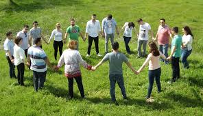 Photo of a circle of people holding hands