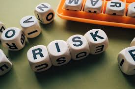 Four dice spelling out 'risk'